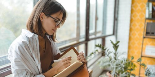 lady writing in book