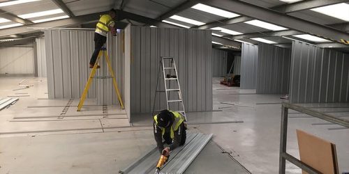 builders working inside storage facility