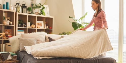 lady making up bed